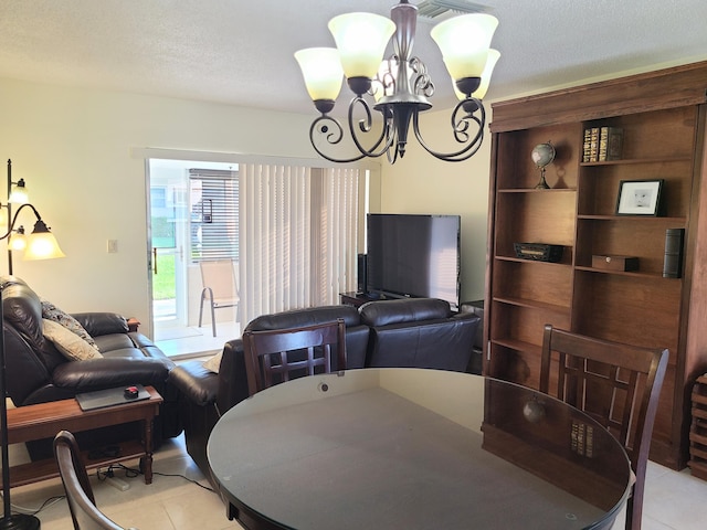 dining area with an inviting chandelier, a textured ceiling, and light tile patterned floors