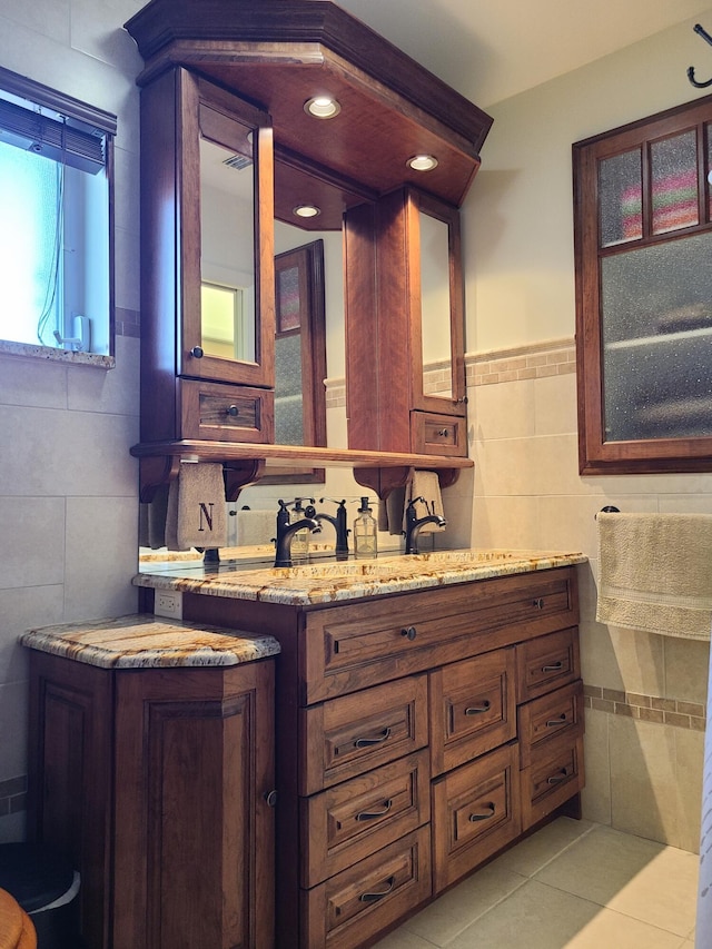 bathroom featuring tile patterned floors, tile walls, and vanity