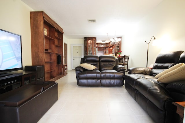 tiled living room with a notable chandelier