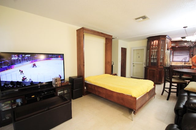 bedroom featuring an inviting chandelier