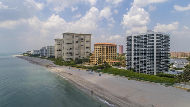 birds eye view of property with a water view and a view of the beach