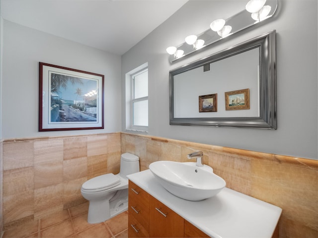 bathroom with vanity, tile walls, tile patterned floors, and toilet