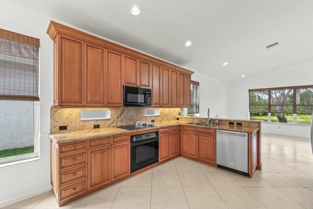 kitchen featuring tasteful backsplash, kitchen peninsula, sink, and black appliances