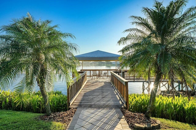 surrounding community with a water view and a gazebo