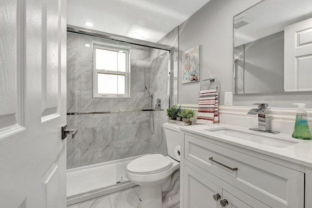 bathroom with vanity, toilet, and walk in shower