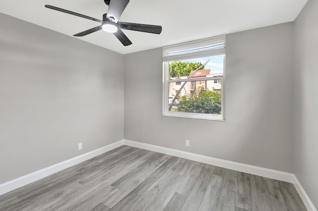 empty room featuring ceiling fan and light hardwood / wood-style floors