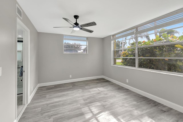 spare room featuring light hardwood / wood-style floors and ceiling fan