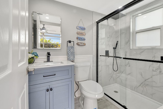 bathroom featuring walk in shower, vanity, and toilet