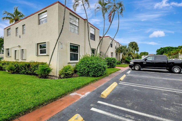 view of parking featuring a yard