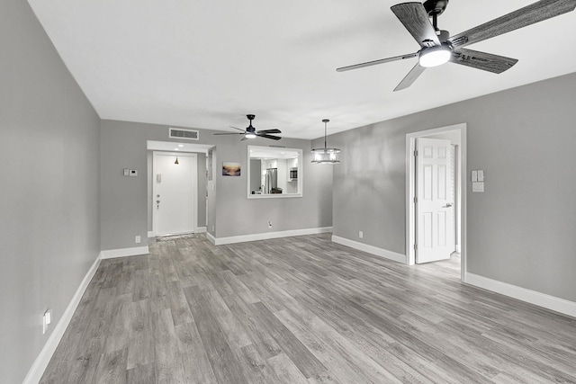 unfurnished living room featuring ceiling fan and light hardwood / wood-style floors