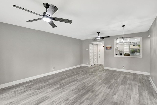 interior space with ceiling fan and light hardwood / wood-style flooring