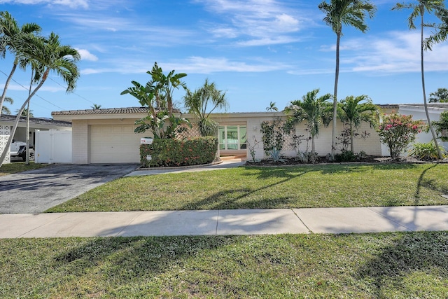 single story home featuring a garage and a front yard