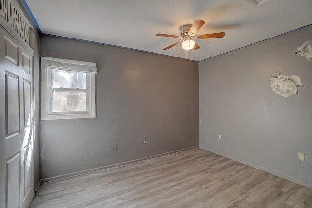 empty room with light hardwood / wood-style floors and ceiling fan