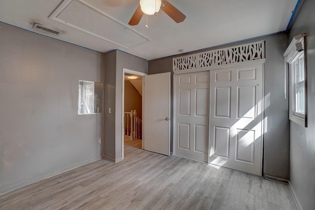 unfurnished bedroom featuring light hardwood / wood-style floors, a closet, and ceiling fan