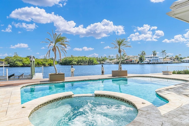 view of swimming pool with a patio area, a pool with connected hot tub, a water view, and a dock