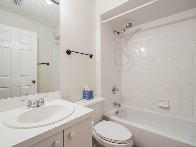 full bathroom with toilet, vanity, a textured ceiling, visible vents, and washtub / shower combination