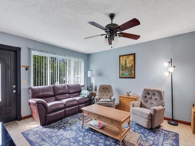 tiled living room with ceiling fan and a textured ceiling