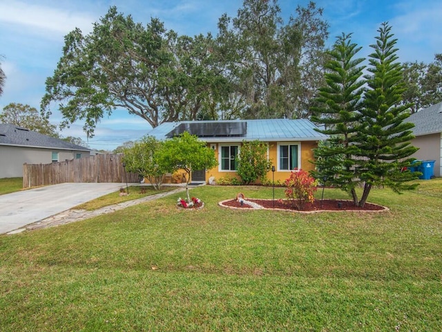 view of front facade with a front yard and solar panels