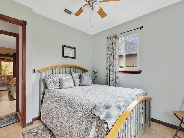 bedroom with light tile patterned flooring, ceiling fan, and multiple windows