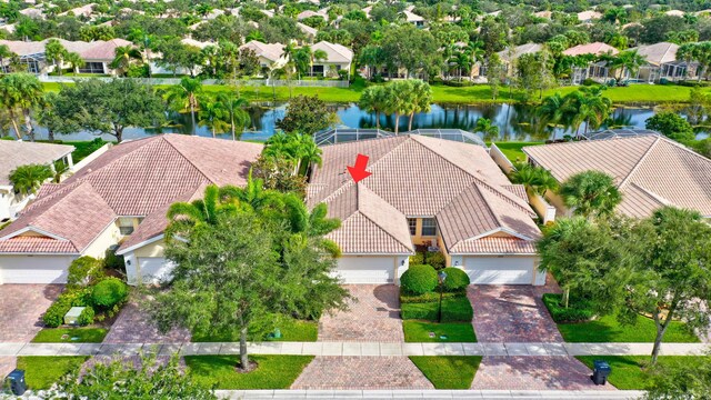 8379 Saint Johns Ct, Wellington, FL 33414 - view of front of home with stucco siding, decorative driveway, a tiled roof, a garage, and a front lawn