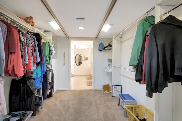 spacious closet featuring light carpet