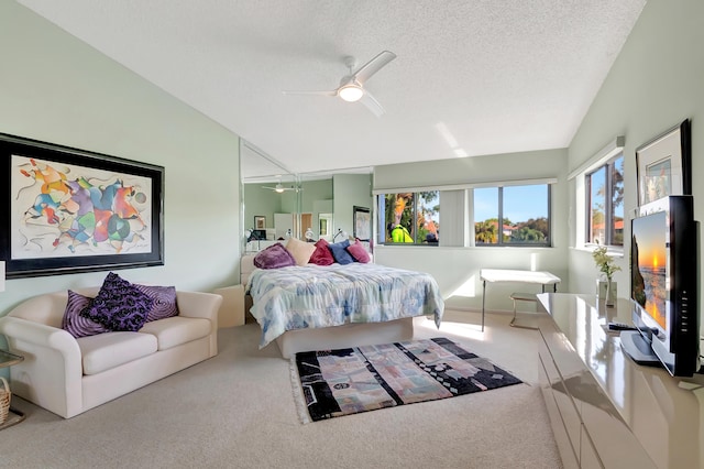 bedroom with ceiling fan, lofted ceiling, carpet, and a textured ceiling