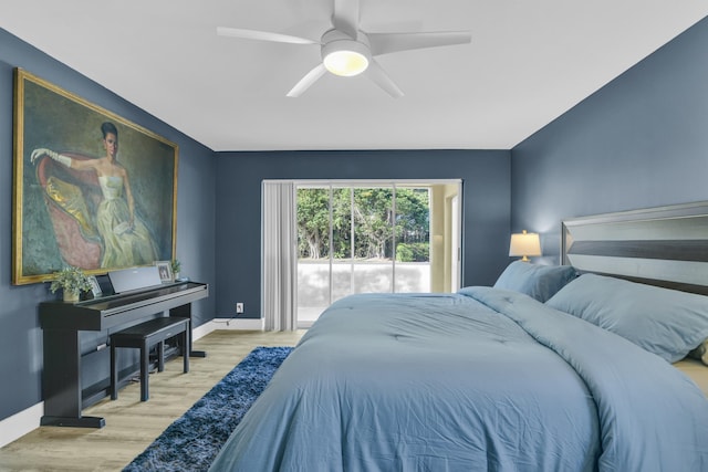 bedroom with ceiling fan, baseboards, and wood finished floors