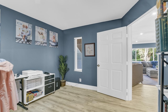 interior space with baseboards and wood finished floors