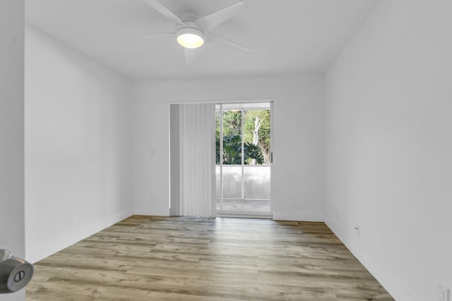 unfurnished room featuring baseboards, a ceiling fan, and wood finished floors