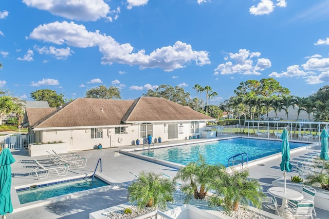 community pool featuring a patio area and fence