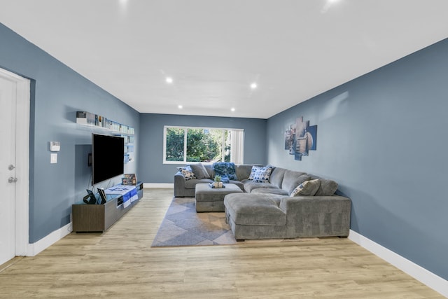 living room with baseboards, wood finished floors, and recessed lighting