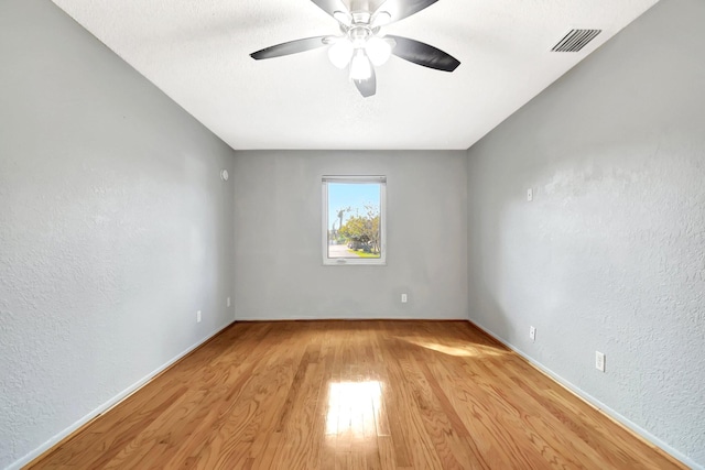 empty room featuring ceiling fan and light hardwood / wood-style flooring