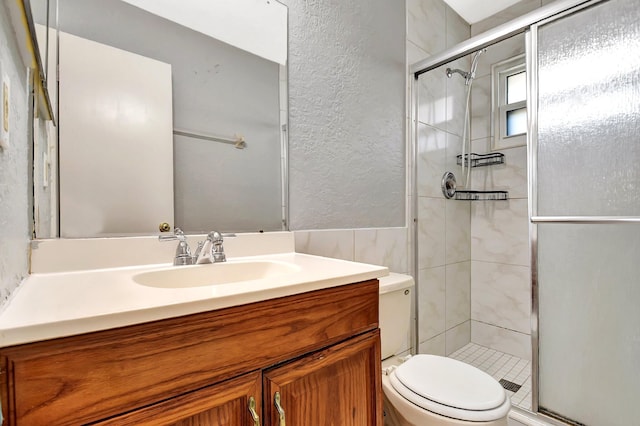 bathroom featuring vanity, toilet, and walk in shower