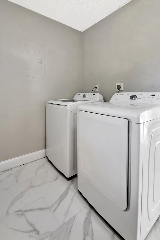 clothes washing area featuring separate washer and dryer