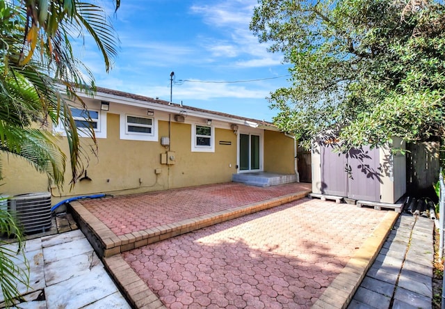 rear view of house with cooling unit and a patio area