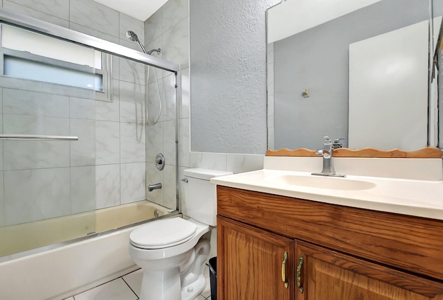 full bathroom featuring bath / shower combo with glass door, vanity, and toilet