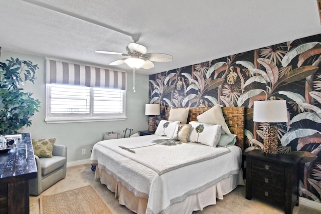 carpeted bedroom featuring ceiling fan and a textured ceiling