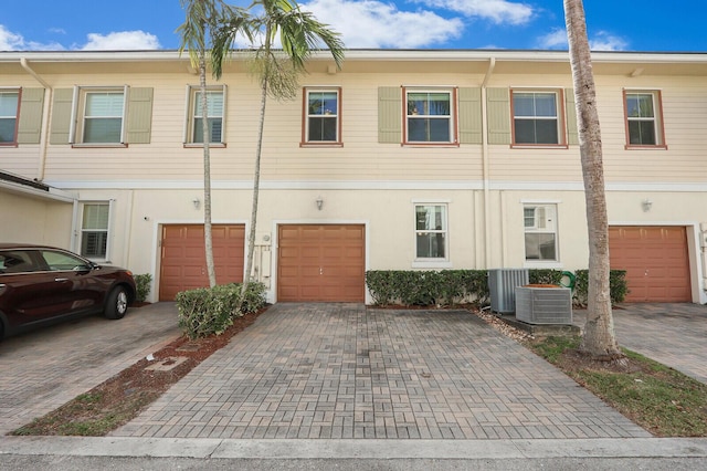 multi unit property featuring cooling unit and a garage