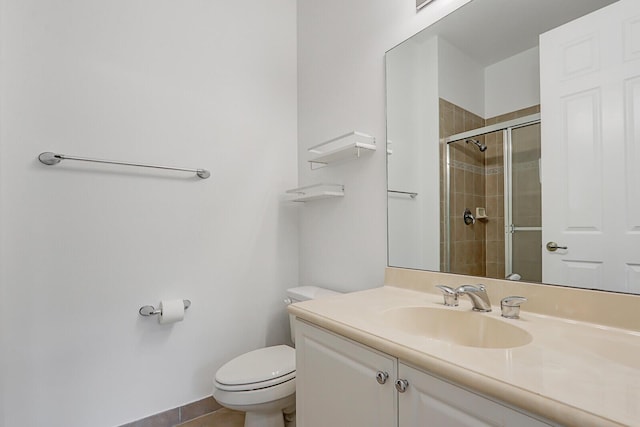 bathroom with vanity, toilet, and a shower with door