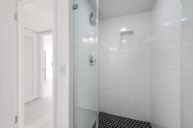 bathroom with a shower with shower door