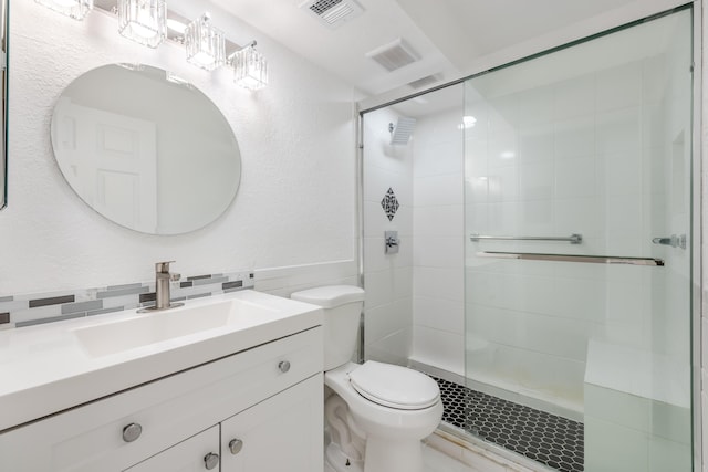 bathroom with vanity, toilet, an enclosed shower, and tile walls