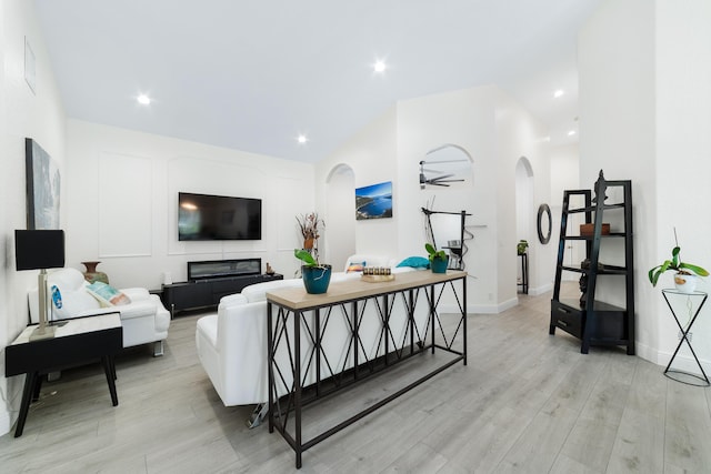 living room featuring ceiling fan and light hardwood / wood-style flooring