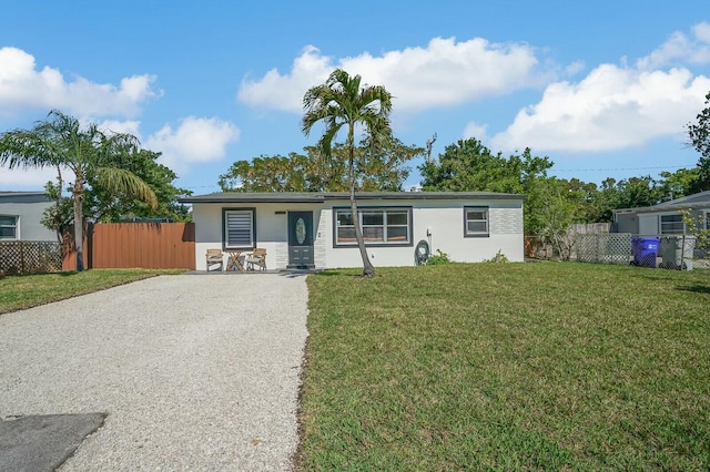 ranch-style home featuring a front yard