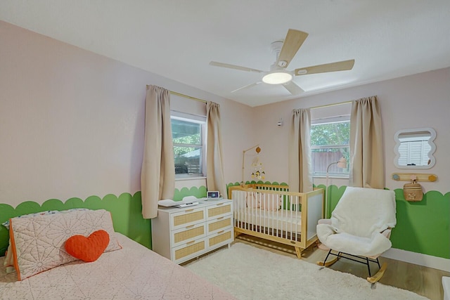 bedroom with wood-type flooring and ceiling fan