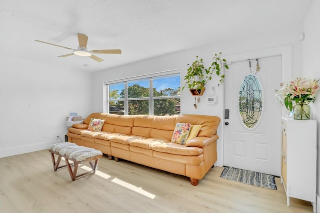 living room featuring ceiling fan and light wood-type flooring