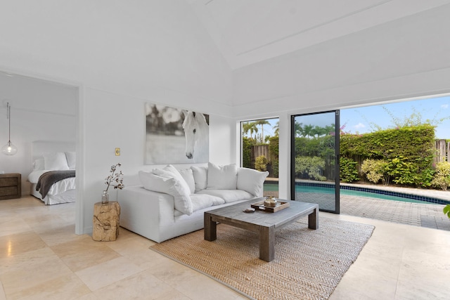 living room with high vaulted ceiling