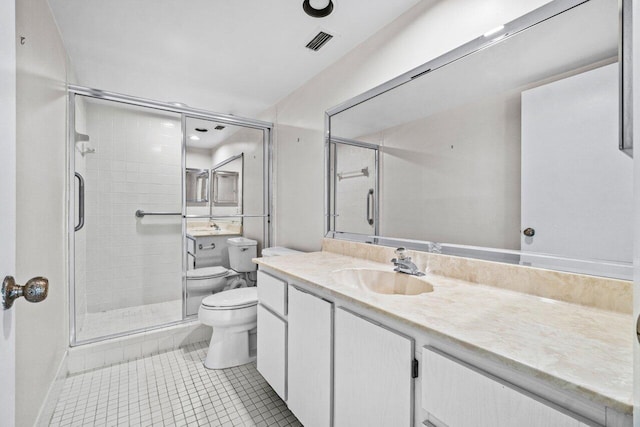 bathroom with tile patterned floors, vanity, toilet, and a shower with shower door