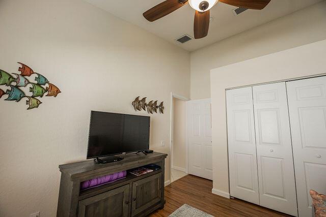 interior space with ceiling fan, lofted ceiling, dark hardwood / wood-style floors, and a closet