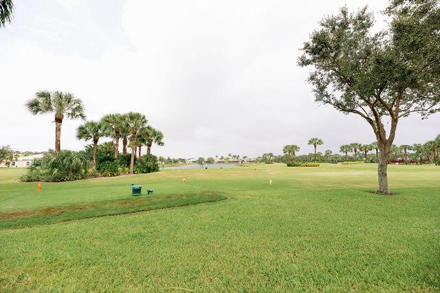 view of property's community with a lawn