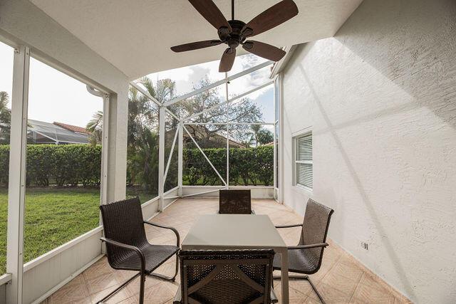 sunroom with a healthy amount of sunlight and ceiling fan